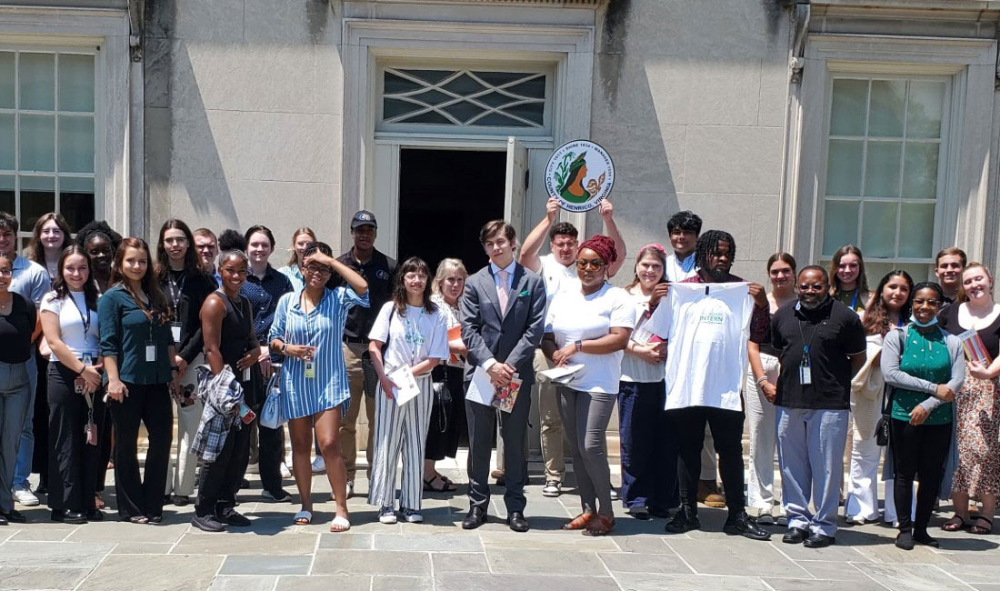 A group of people standing in front the building